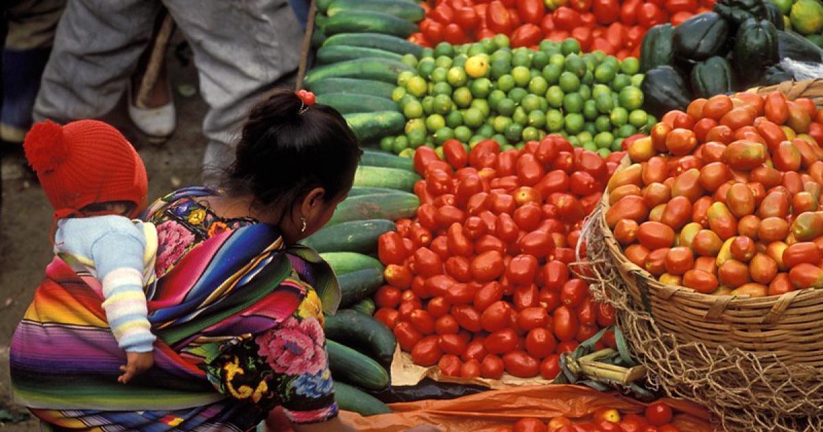 Buying tomatoes at the market, Solola, Guatemala. Photo credit Curt Carnemark, World Bank