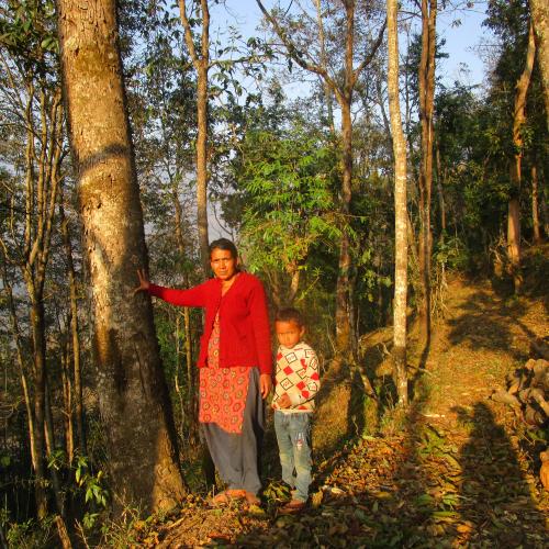 Private forest owner in Sindhupalkchok with her son. Courtesy of Ganga Neupane